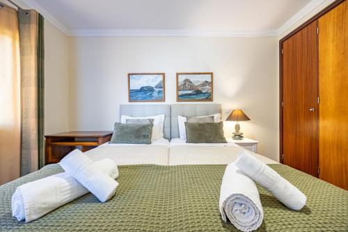 a bedroom with two beds and a desk at Ocean Lido in Funchal