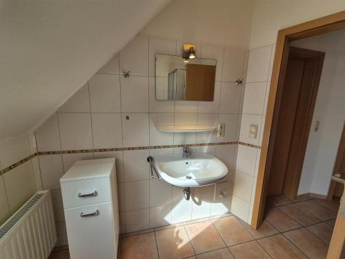 a bathroom with a sink and a mirror at Atlantik-Kolk 30 in Norddeich