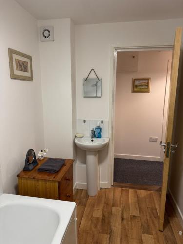 a bathroom with a sink and a toilet and a tub at Warm, Sleeps 6, Bathroom, Beaches Shops Cafes Bars Pier, Central Ryde in Ryde