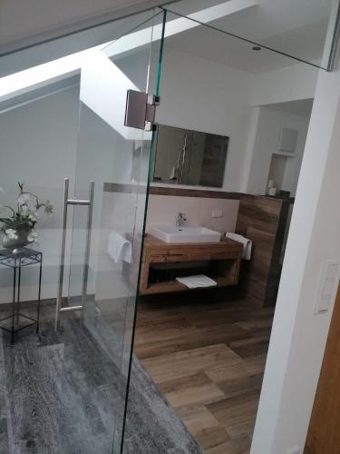 a bathroom with a glass shower and a sink at Haslgut in Fuschl am See