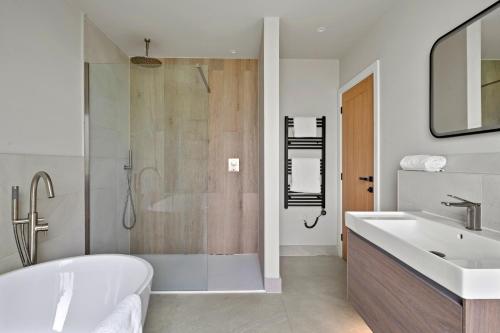 a bathroom with a tub and a sink and a shower at Finest Retreats - Orchard Rise in Bude