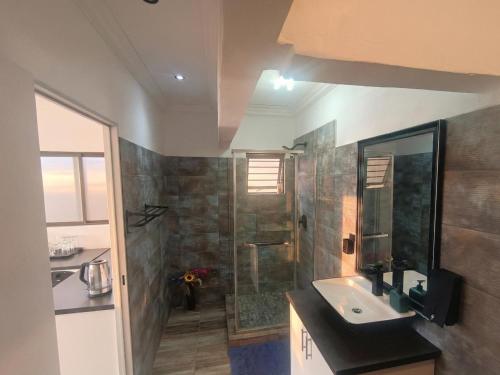 a bathroom with a sink and a shower at Van Gogh - Zur See in Ballito