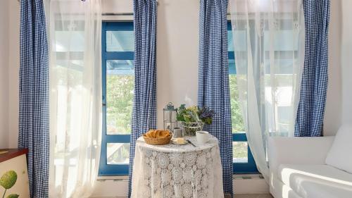 a room with blue curtains and a table in front of a window at Ganghwa Picnic Pension in Incheon