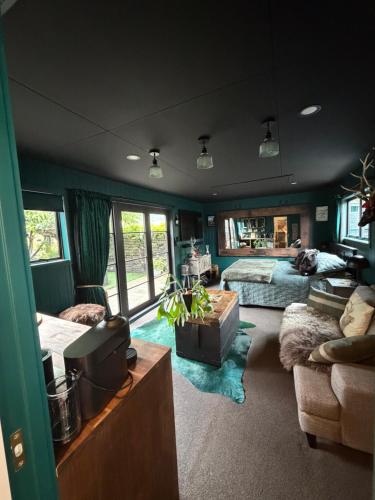 a bedroom with a bed and a bed and a couch at The Olde Whiskey Room in Queenstown