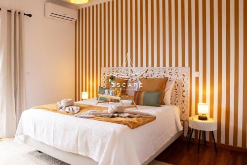 a bedroom with a bed with two stuffed animals on it at Vila Sol in Prazeres