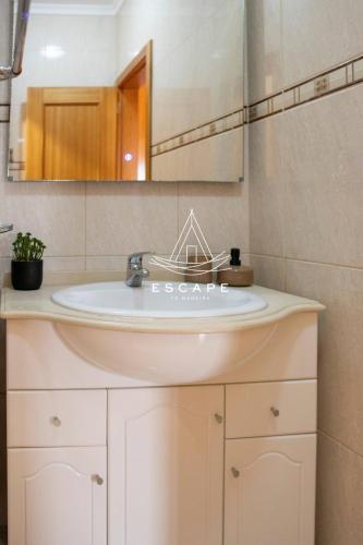 a bathroom with a sink and a mirror at Vila Sol in Prazeres