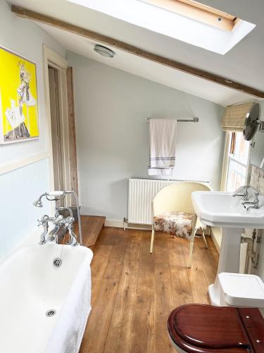 a bathroom with two sinks and a table at The Artist's House in Norwich
