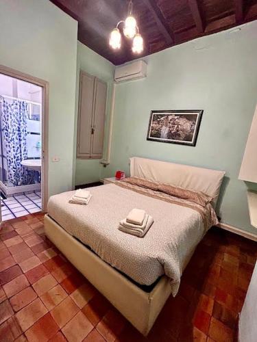 a bedroom with a bed with two towels on it at The Father s House in Rome