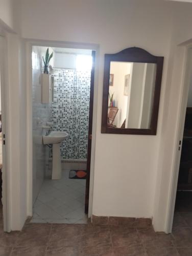 a bathroom with a mirror and a sink at JOAQUINA in Ramallo