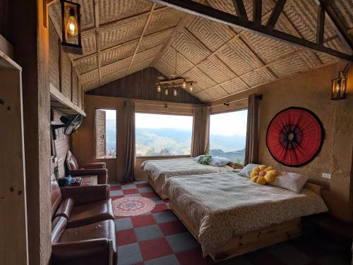 a bedroom with two beds and a large window at Charming Home Tà Xùa in Bắc Yên