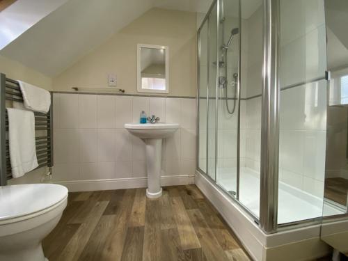 a bathroom with a shower and a toilet and a sink at Spacious Bracknell Four Bedroom House in Bracknell