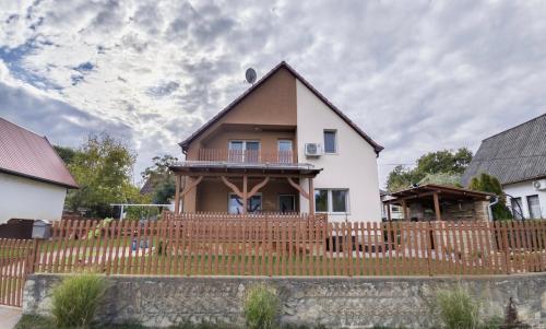 a house with a wooden fence in front of it at Vadvirág 5 by DunaVibe in Baja