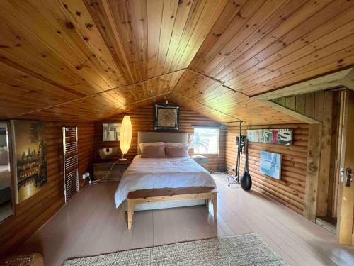a bedroom with a bed and a wooden ceiling at Dublin Seaview Cabin in Rathfarnham