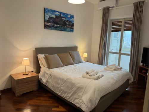 a bedroom with a bed with two towels on it at Sparano Top Class 7 in Bari