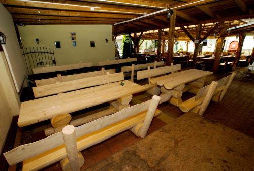 a group of wooden benches in a building at Villa Marcus - rodinný relax 200 m od Penzionu Kometa, u jezera s grilem a sdílenou kuchyní in Pasohlávky