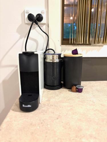 a computer monitor sitting on a counter next to two trash cans at Shell Shack in Tomakin