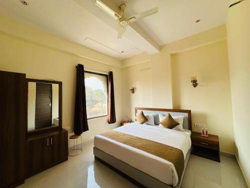 a bedroom with a large bed and a window at Hotel The Maya Palace in Jaipur