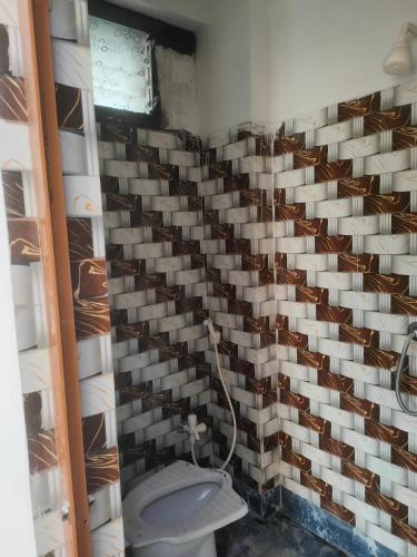a room with a wall full of wine glasses at Laxmi Narasimha Hotel in mayapur