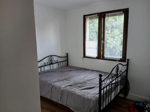 a bedroom with a bed in a room with a window at Air-conditioned villa with pool in Mèze
