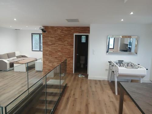 a living room with a staircase and a brick wall at Air-conditioned villa with pool in Mèze