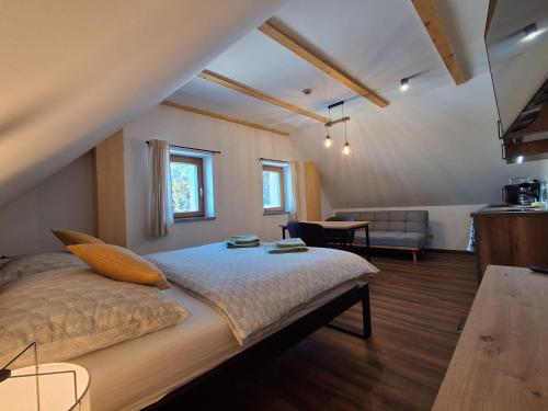 a bedroom with a bed and a living room at Apartmány pod Štěpánkou in Kořenov