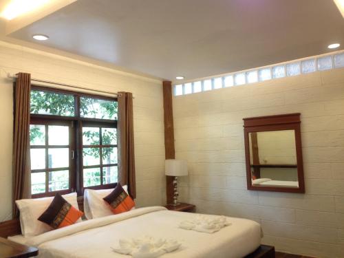 Ένα ή περισσότερα κρεβάτια σε δωμάτιο στο Treasure Inn Khaoyai