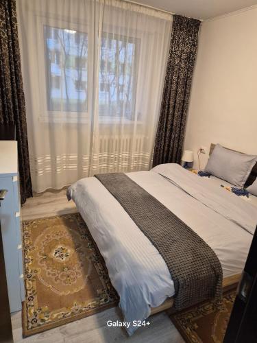 a bedroom with a bed and a window with curtains at ARTIFICII București in Bucharest