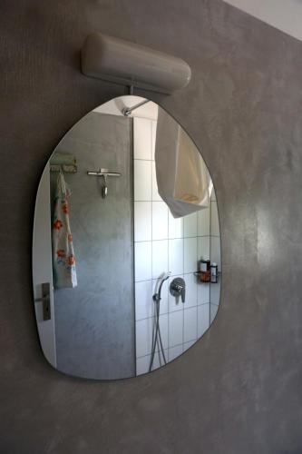 a mirror in a bathroom with a shower at Villa Tsakalaki in Stavríon