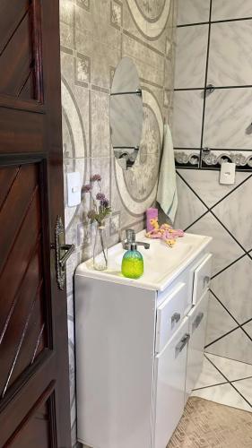 a bathroom with a sink and a mirror at Pousada Nunes in Lauro Müller