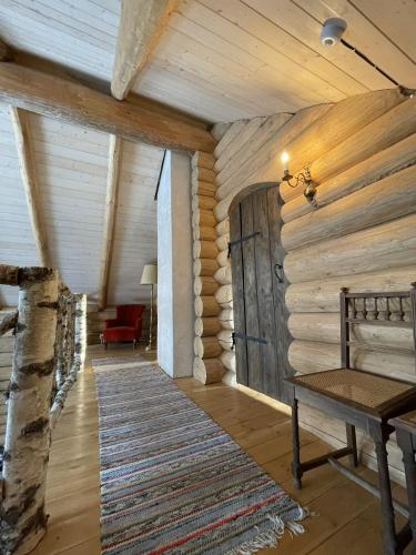 a hallway with a wooden wall with a wooden door at Nordic Log-House with Sauna in Valga