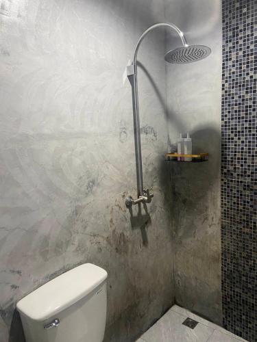 a bathroom with a toilet and a shower at Phumaihom Resort in Hat Yai