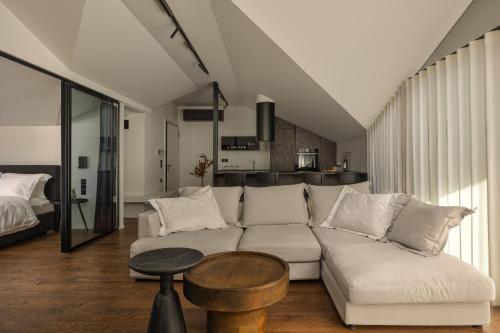 a living room with a white couch and a table at The Lake Loft in Ioannina