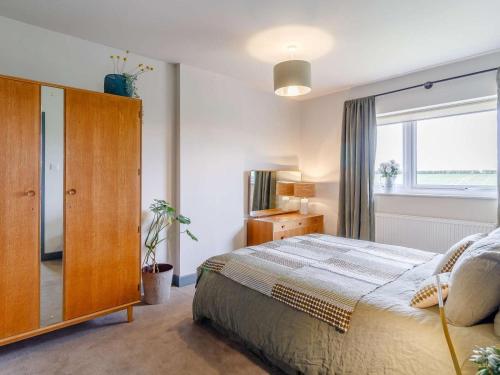 a bedroom with a bed and a large window at 3 Bed in Kings Lynn oc-82358 in Harpley