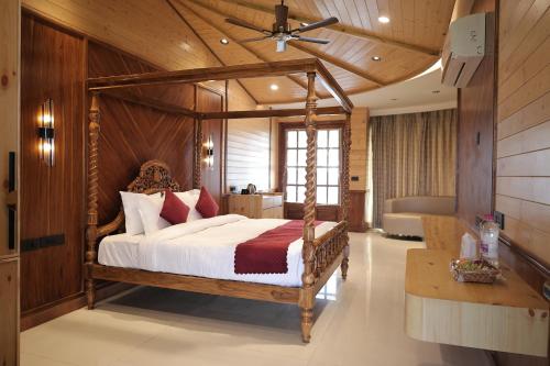 a bedroom with a canopy bed in a room at Namaste Corbett Resort and Spa in Jāmb