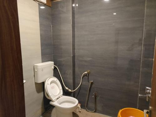 a bathroom with a toilet and a shower at Infinity inn in Guna