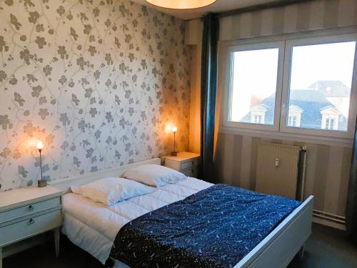 a small bedroom with a bed and a window at Le Nid du Remblai in Les Sables-d'Olonne