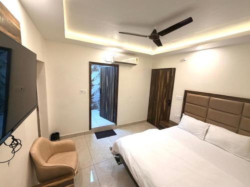 a bedroom with a bed and a ceiling fan at GRACE Inn in Dehradun