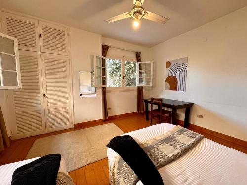 a bedroom with a bed and a table in it at Villa Maadi 35 - R 205- Pool View Room in Cairo