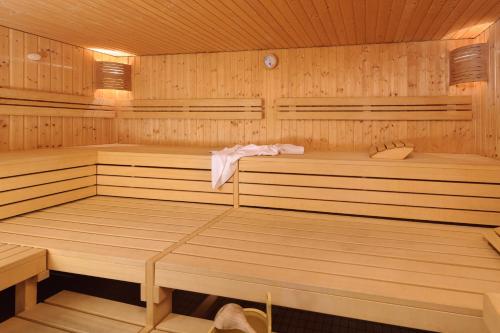 a wooden sauna with two saunas and a towel at Mercure Stuttgart Sindelfingen an der Messe in Sindelfingen