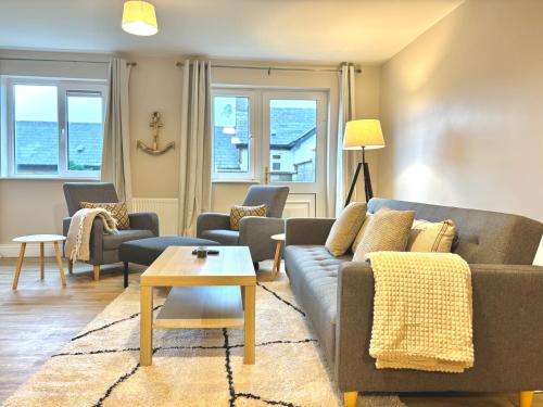a living room with a couch and chairs and a table at Cobh Panorama- Sea & Cathedral Views in Cobh