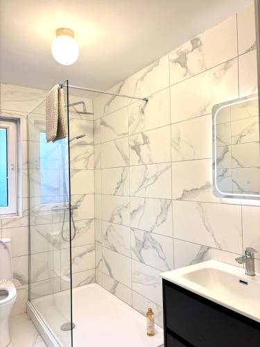 a bathroom with a shower and a sink at Cobh Panorama- Sea & Cathedral Views in Cobh