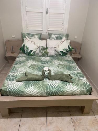 a large bed with a person laying on it at Milles Eclats in Les Anses-dʼArlets
