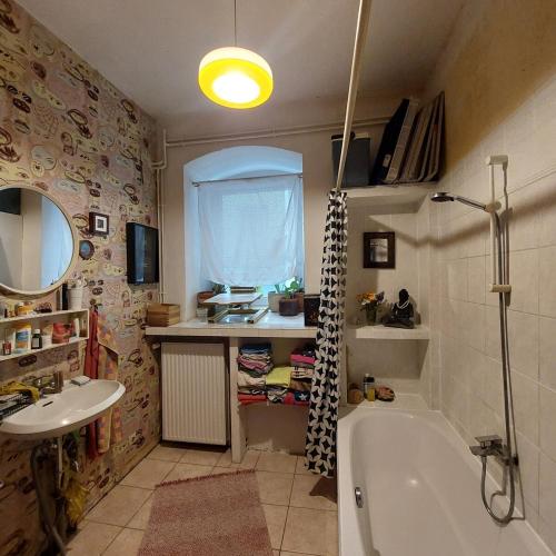 a bathroom with a bath tub and a sink at Crystal Ball Residency in Berlin