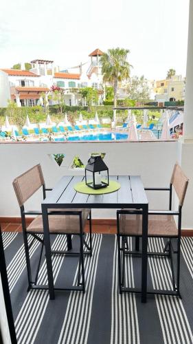 a table and chairs on a balcony with a view at Old Village in Vilamoura
