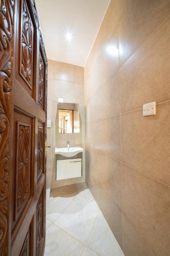 a bathroom with a sink and a shower at Beat's Hideaway in Galu