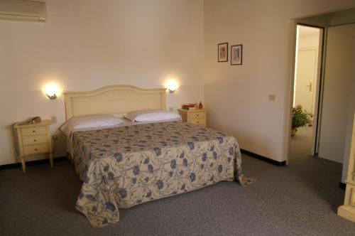 a hotel room with a bed and two night stands at Hotel Calzaiolo in San Casciano in Val di Pesa