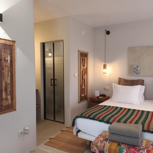 a bedroom with a bed and a sliding glass door at Casa do Campinho B&B boutique guest house in Reguengos de Monsaraz
