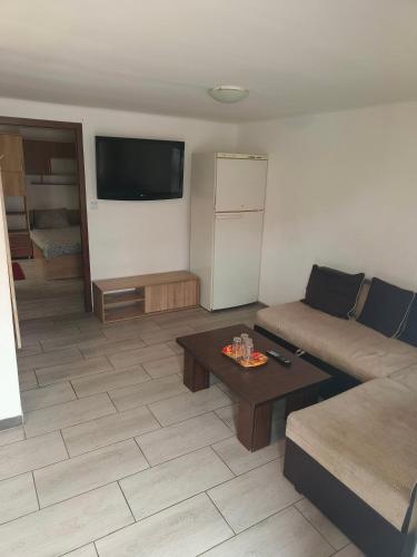 a living room with a couch and a table at Casa Razu G2 in Craiova