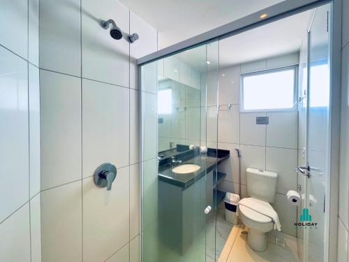 a bathroom with a toilet and a sink and a shower at Aquarius Style by Holiday Stays in Fortaleza