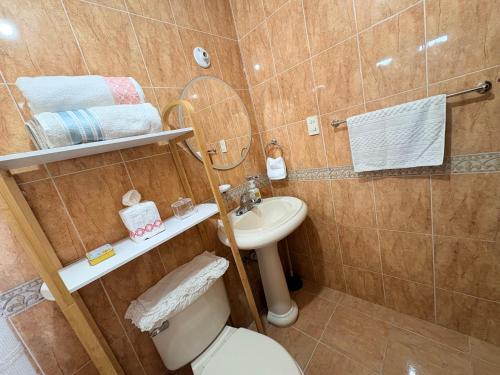 a bathroom with a toilet and a sink at Casa Lauren Del Sol en Zona Dorada de Tampico in Tampico